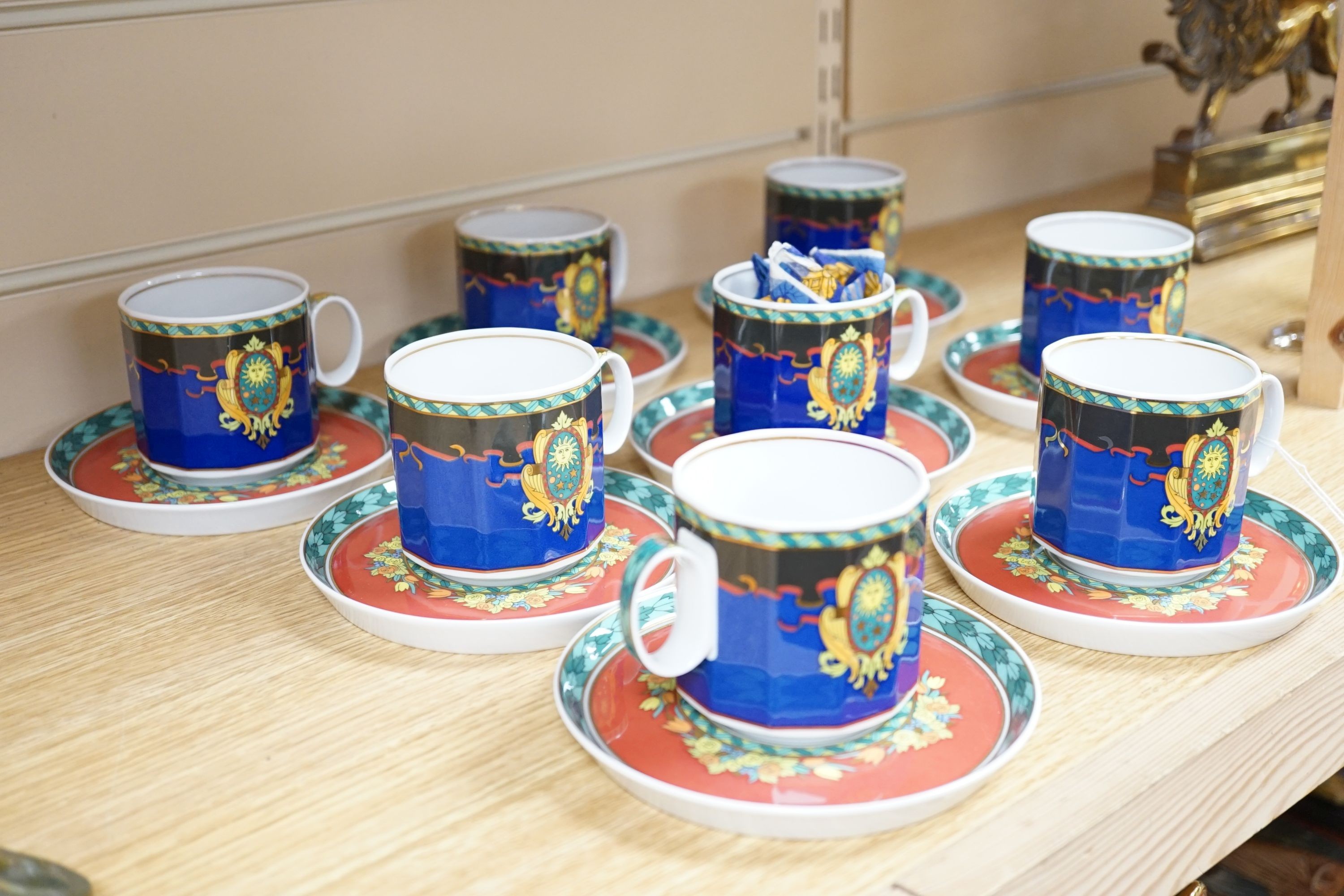 A set of eight Versace 'Le Roi Soleil' pattern cups and saucers
